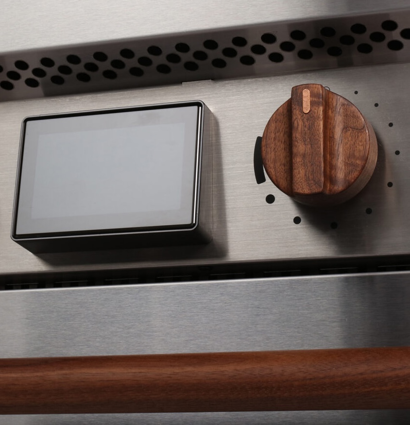 Hand turning a walnut knob on a Copper range