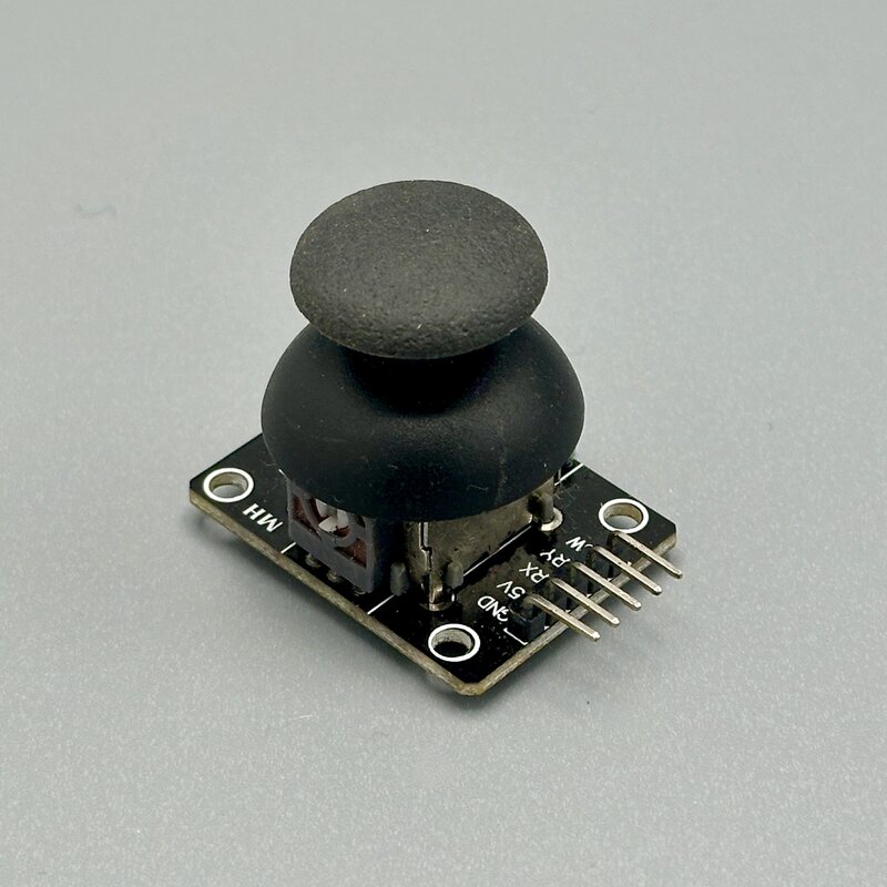 A 2-axis analog joystick module — two potentiometers report X and Y position, and pressing down on the stick clicks a third, button pin. Photo by the Author