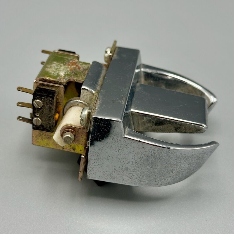 A hook switch salvaged from a telephone handset cradle, closing when the handset rests down and opening when it's lifted. Photo by the Author